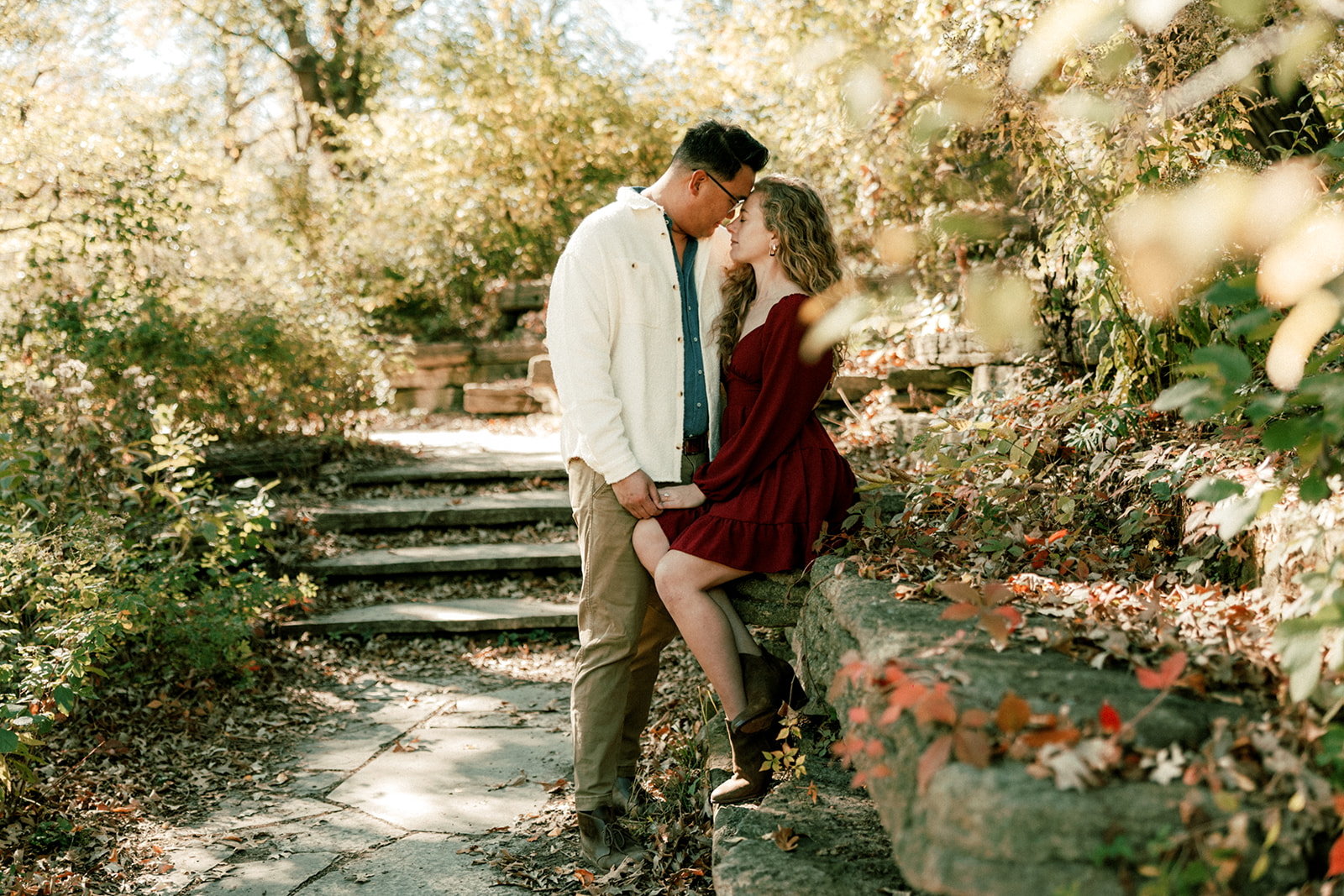 Kelly and Jin share a quiet moment during their autumn engagement session at the Alfred Caldwell Lily Pool in Lincoln Park, Chicago.
